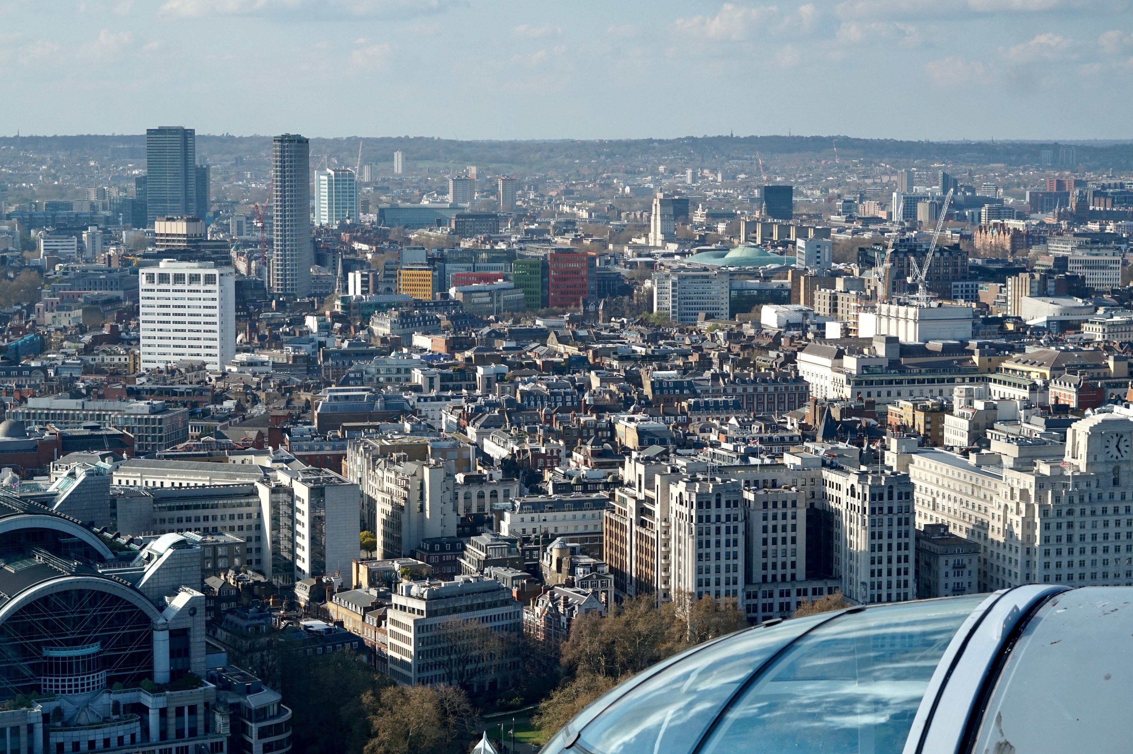 Panoramic aerial view of modern London cityscape with iconic skyline buildings.